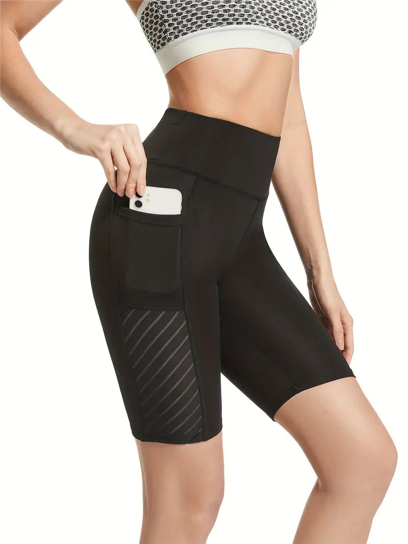 Shorts sólidos sem costura com bolsos para telefone
